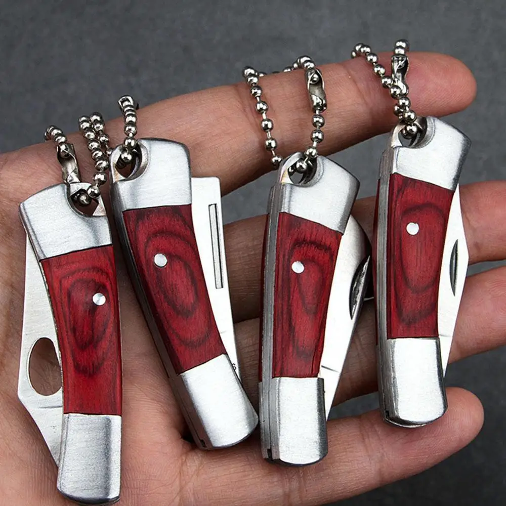 1PC Necklace Folding Blade Knife Mini Pocket Wallet Key Ring Knives Survival EDC Tool Peeler Christmas Gift Keychain
1PC Necklace Folding Blade Knife Mini Pocket Wallet Key Ring Knives Survival EDC Tool Peeler Christmas Gift Keychain