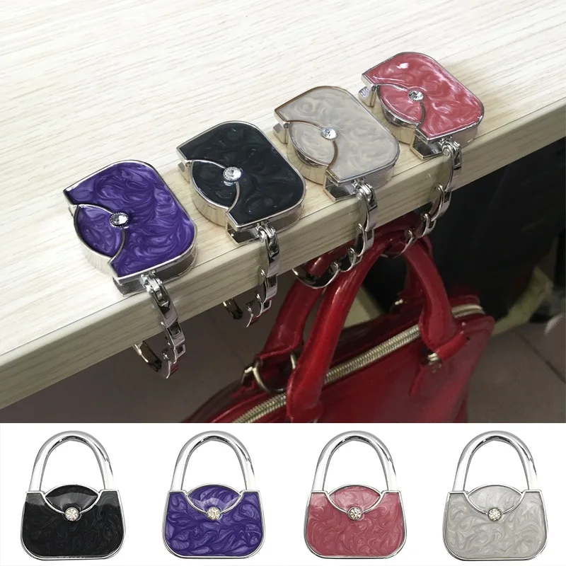 Foldable Purse Hooks Portable Folding Bag Hook Hanger Crystal Alloy Handbag Storage Rack Creative Desk Pouch Holder Home Decor 
Foldable Purse Hooks Portable Folding Bag Hook Hanger Crystal Alloy Handbag Storage Rack Creative Desk Pouch Holder Home Decor