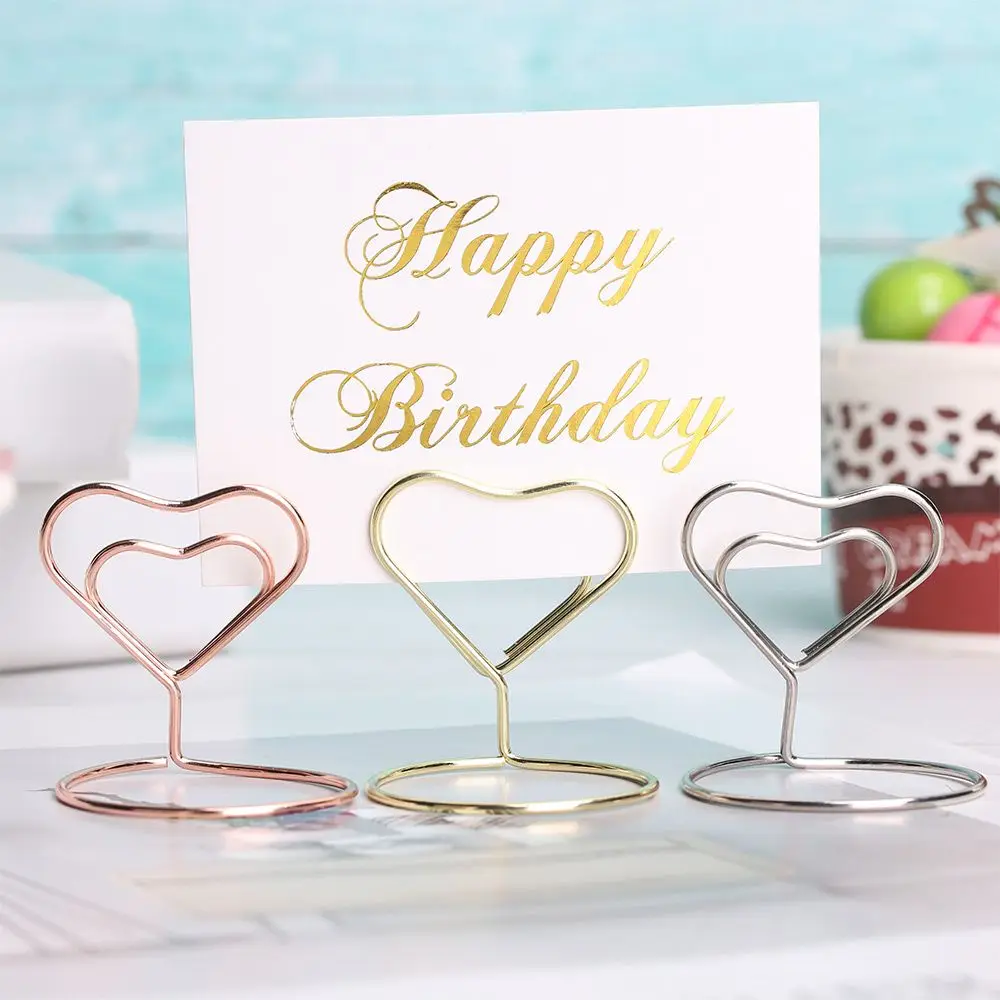 1PC Rose Gold Heart Shape Paper Clamp Ring Shape Clamps Stand Place Card Table Numbers Holder Photos Clips Wedding Supplies
1PC Rose Gold Heart Shape Paper Clamp Ring Shape Clamps Stand Place Card Table Numbers Holder Photos Clips Wedding Supplies