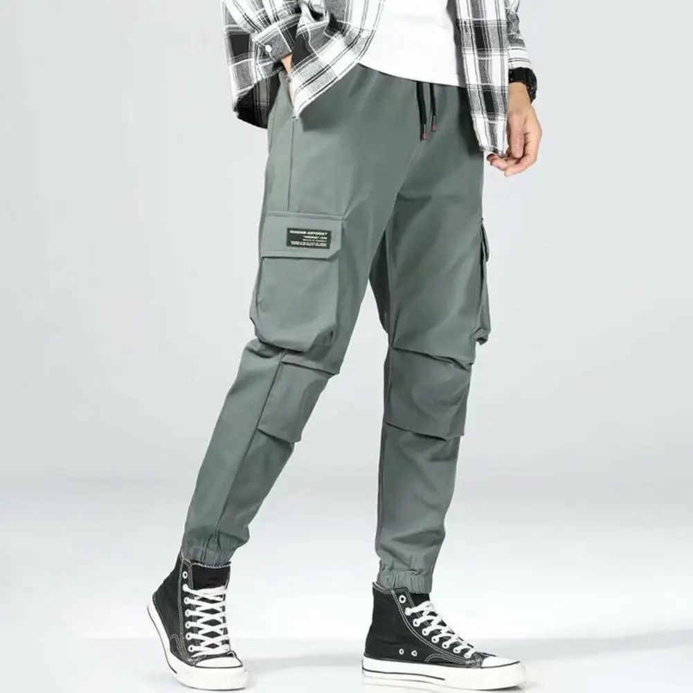 Autumn Men Cargo Pants Solid Color Elastic Waist Drawstring Multi Pockets Trousers Lace-up Mid-rise Harem Pants
Autumn Men Cargo Pants Solid Color Elastic Waist Drawstring Multi Pockets Trousers Lace-up Mid-rise Harem Pants