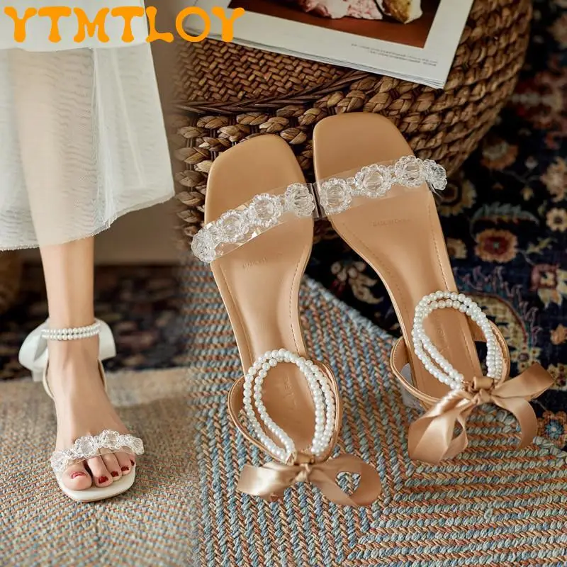 French Mid-heel Pearl Strap Sandals Women's Thick Heel 2021 Summer Bow Transparent One Word With Crystal High Heels
French Mid-heel Pearl Strap Sandals Women's Thick Heel 2021 Summer Bow Transparent One Word With Crystal High Heels