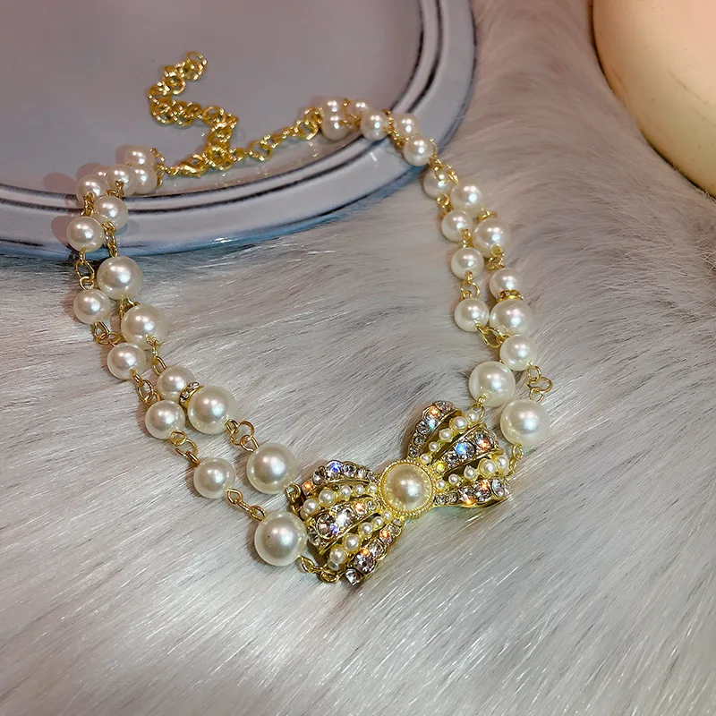 HIYONG Luxury Pearl Bow Pendant Necklace Double Layered Bowknot Rhinestone Necklace Party Girls Clavicle Choker Accessories
HIYONG Luxury Pearl Bow Pendant Necklace Double Layered Bowknot Rhinestone Necklace Party Girls Clavicle Choker Accessories