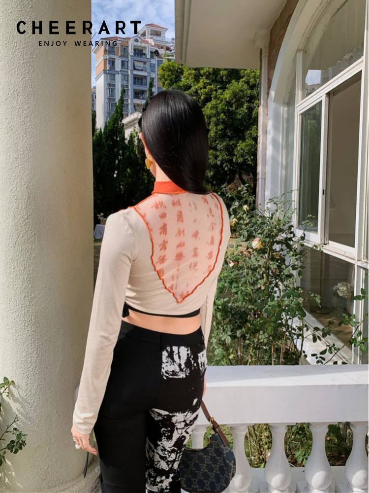 CHEERART Halter Crop Top Women 2022 Mesh Patchwork Long Sleeve Tees Character Print Beige T Shirt Designer Top Summer Clothes 
CHEERART Halter Crop Top Women 2022 Mesh Patchwork Long Sleeve Tees Character Print Beige T Shirt Designer Top Summer Clothes