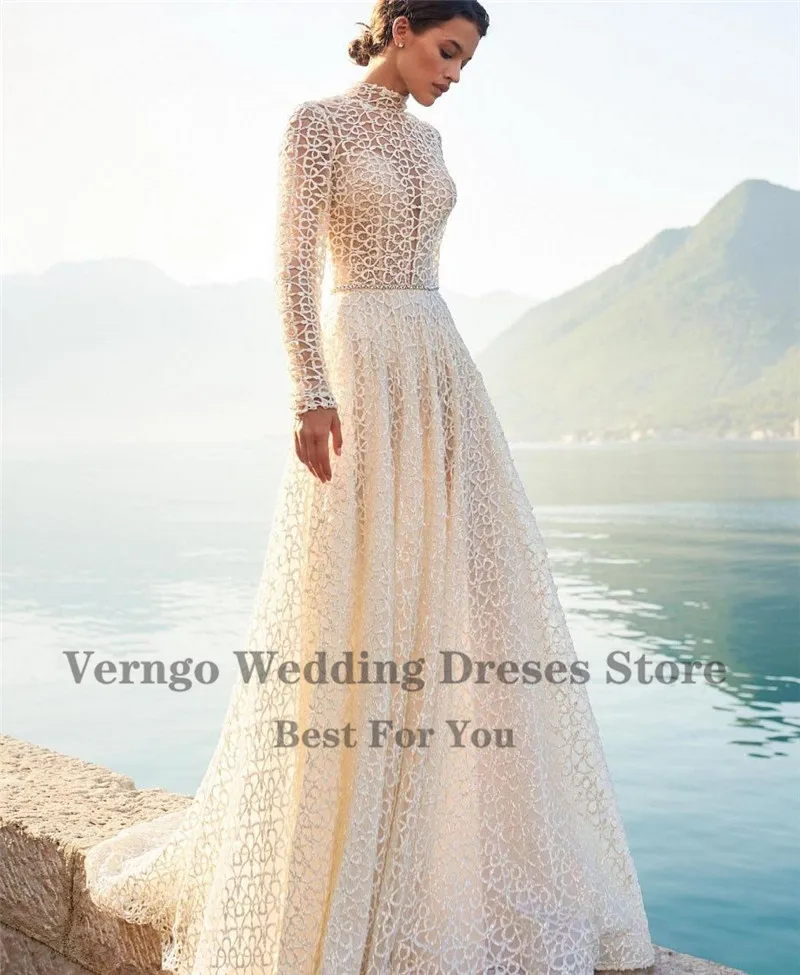 Verngo Elegant High Neck Full Lace Wedding Dress Long Sleeves Boho A Line 2021 Bride Gowns Open Back Glitter Crystal Sash
Verngo Elegant High Neck Full Lace Wedding Dress Long Sleeves Boho A Line 2021 Bride Gowns Open Back Glitter Crystal Sash
