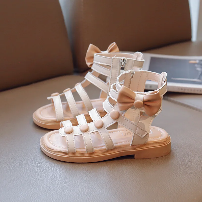 Сандалии для девочек, Новинка лета 2023, пляжная обувь с бантом и открытым носком для принцесс, детские туфли с высоким верхом, на молнии, римские туфли, мягкая подошва, детская обувь на плоской подошве 
Сандалии для девочек, Новинка лета 2023, пляжная обувь с бантом и открытым носком для принцесс, детские туфли с высоким верхом, на молнии, римские туфли, мягкая подошва, детская обувь на плоской подошве