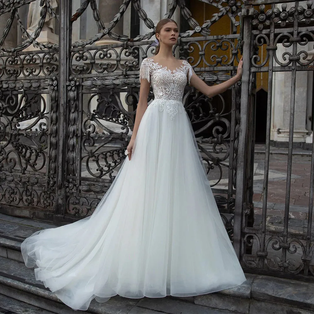 Elegant A-Line Tulle Wedding Dresses 2022 Cap Sleeve O-Neck Formal Lace Bridal Gown With Button Back Sweep Train
Elegant A-Line Tulle Wedding Dresses 2022 Cap Sleeve O-Neck Formal Lace Bridal Gown With Button Back Sweep Train