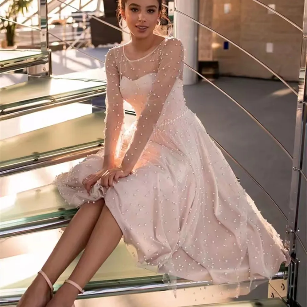 Modest Blush Pink Full Pearls Short Wedding Party Dress Sheer Long Sleeves Jewel Neck Tea Length Bride Formal Gowns
Modest Blush Pink Full Pearls Short Wedding Party Dress Sheer Long Sleeves Jewel Neck Tea Length Bride Formal Gowns