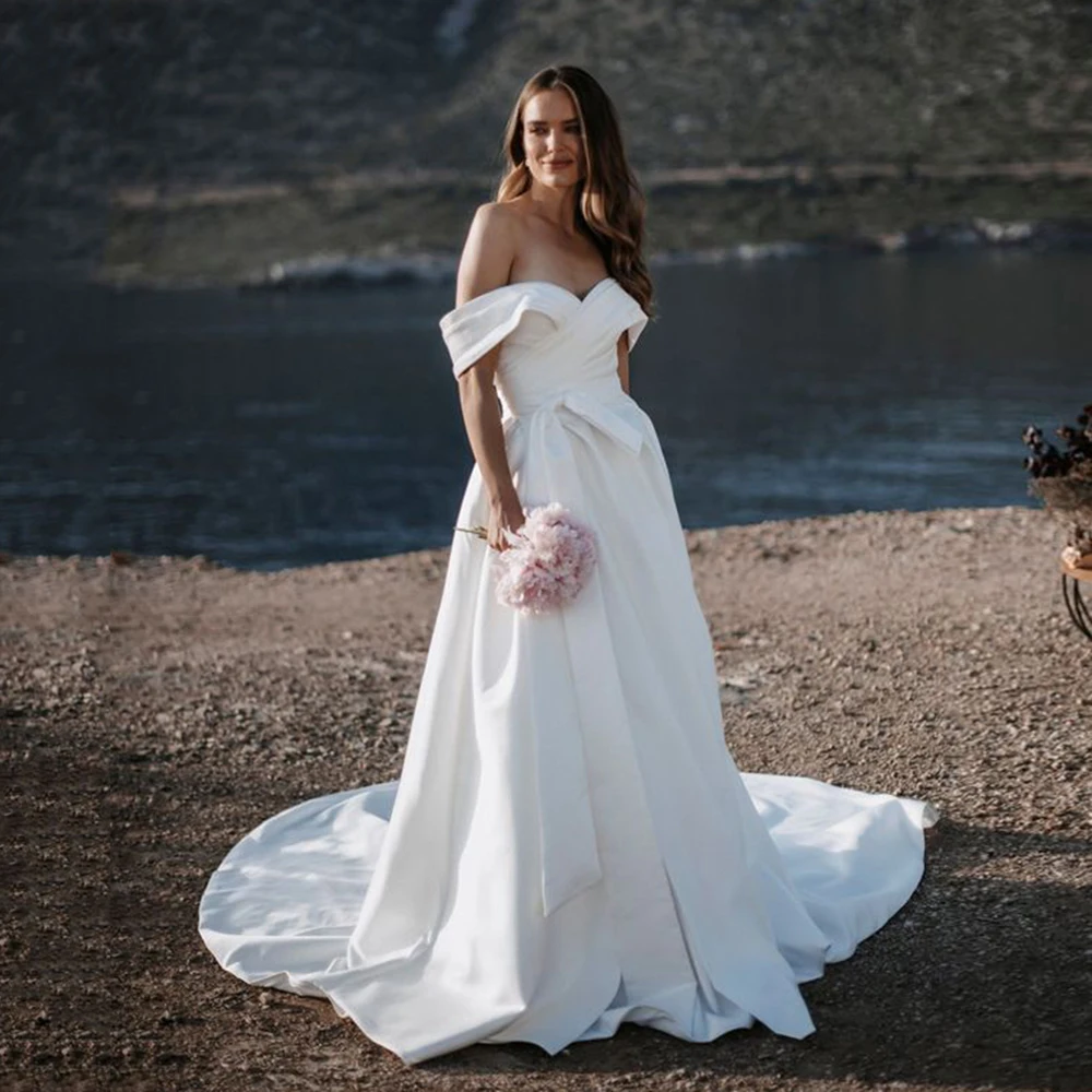 

Ohmmayby Ivory A Line Wedding Dresses Off The Shoulder Bow Detail Cathedral Train Satin Backless Bride Gown Vestido De Noiva