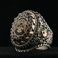 Sovereign Black Amber Oval Men's Silver Ring There is a Seljuk motif double-headed eagle on the upper part. Black qarnet stones