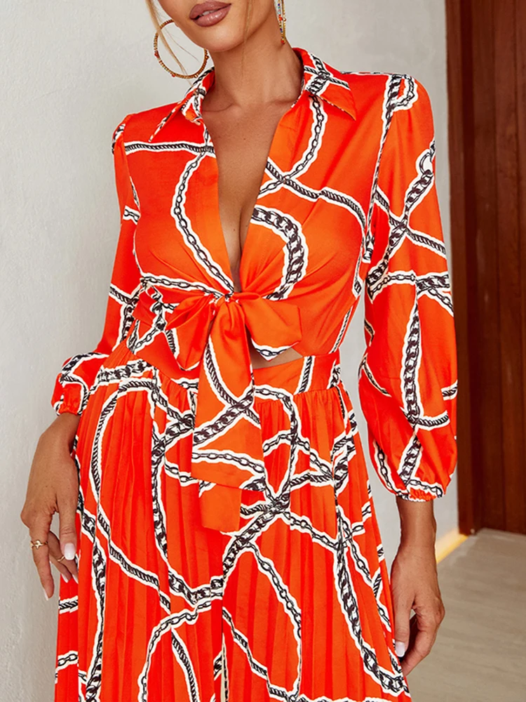 

Glamaker 2022 Autumn Orange Chain Print Jumpsuit Women Sexy Chest Knot Hollow Out Lantern Sleeve V-neck Wide-leg Pleated Rompers