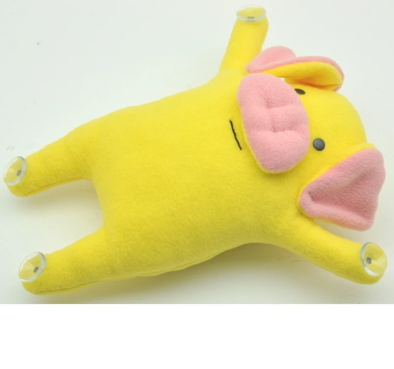 Toy snoogy pig yellow with suction cups on the |