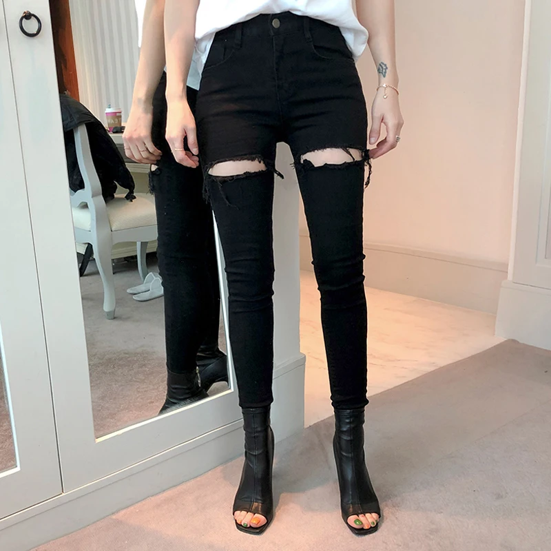 Женские эластичные джинсы черные рваные с бахромой на подоле уличные узкие