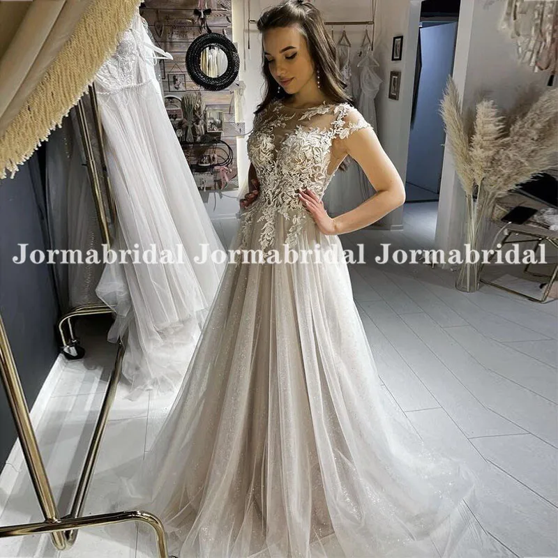 

Illusion Cap Sleeve Lace Appliqued Boho Wedding Dresses See Through Buttons Back Champagne Glitter Tulle Beach Bridal Gowns