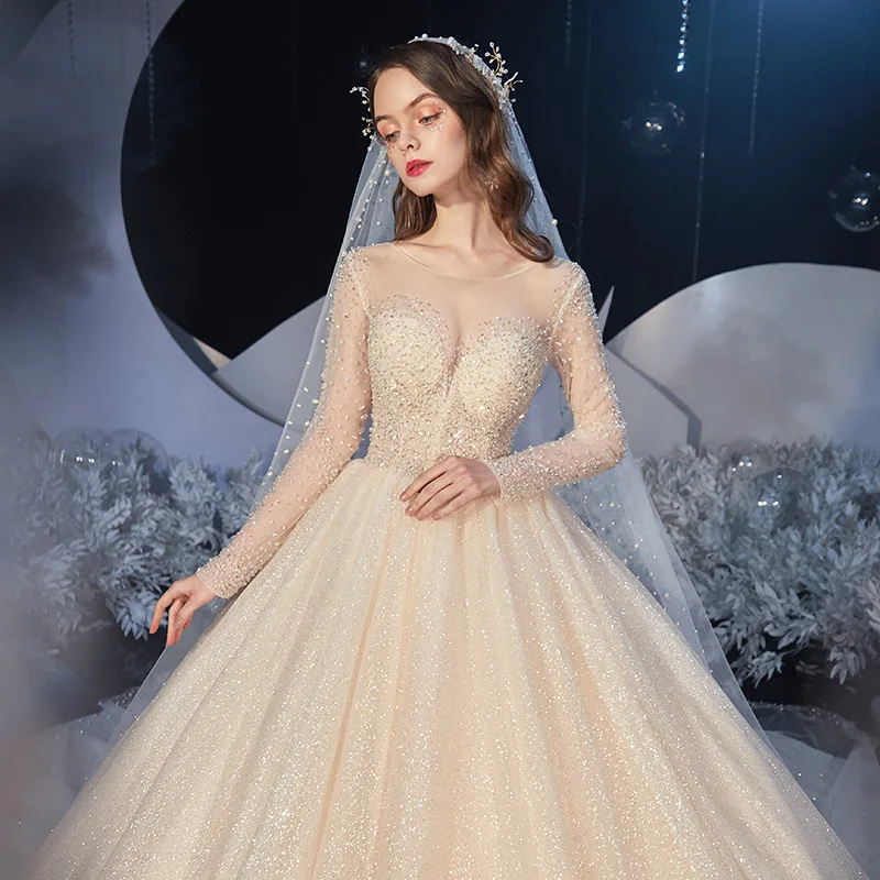 

Luxury Princess Wedding Dress Long Sleeves O-Neck Beading Sequins Shiny Champagne Chapel Train Saudi Sexy Illusion Bridal Gowns