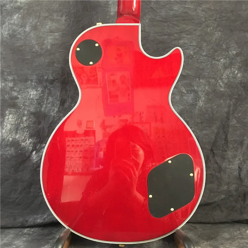 

High-quality left-handed electric guitar, gold hardware, top maple flame, red. Free shipping, top quality.