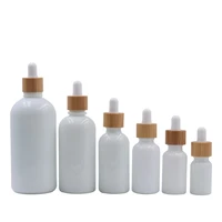 customized hot sell white porcelain bottles round serum bottle with bamboo dropper lid cap essential oil cosmetic containers