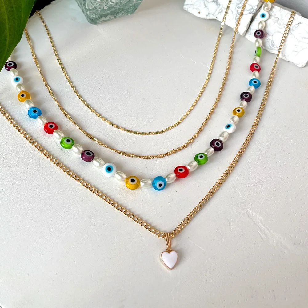 

JUST FEEL Multilayer Colorful Evil Eye Glass Beads Pearl Necklace for Women Trendy Heart Metal Chain Necklace Pendant Jewelry