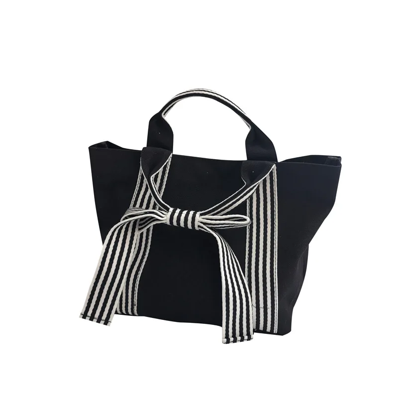 

Dongdaemun fashion simple bow canvas bag female hand-held dark small fresh handbag