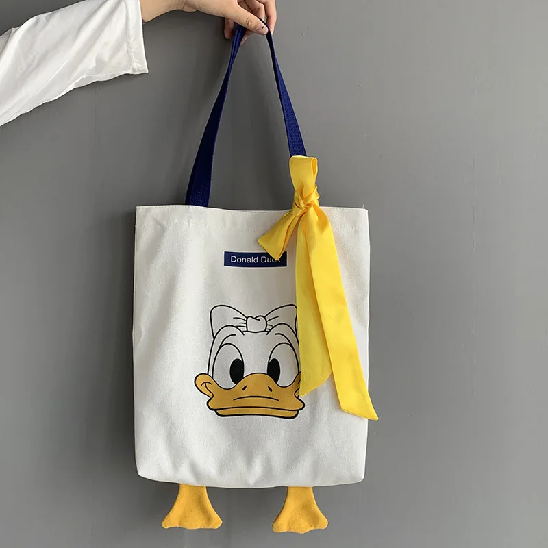 

39x34cm Donald Duck Yellow Ribbon Bow Cute Women Canvas Shoulder Bag Large Capacity Student Canvas Shoulder Bag