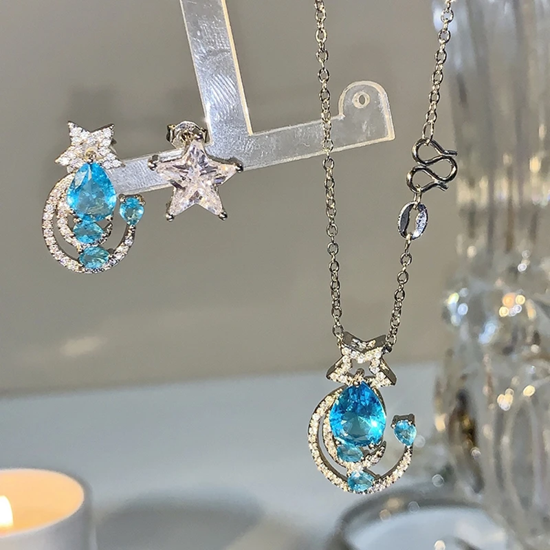 

MENGJIQIAO New Elegant Blue Waterdrop Crystal Stud Earrings For Women Asymmetric Cute Delicate Zircon Moon Pendientes Jewelry