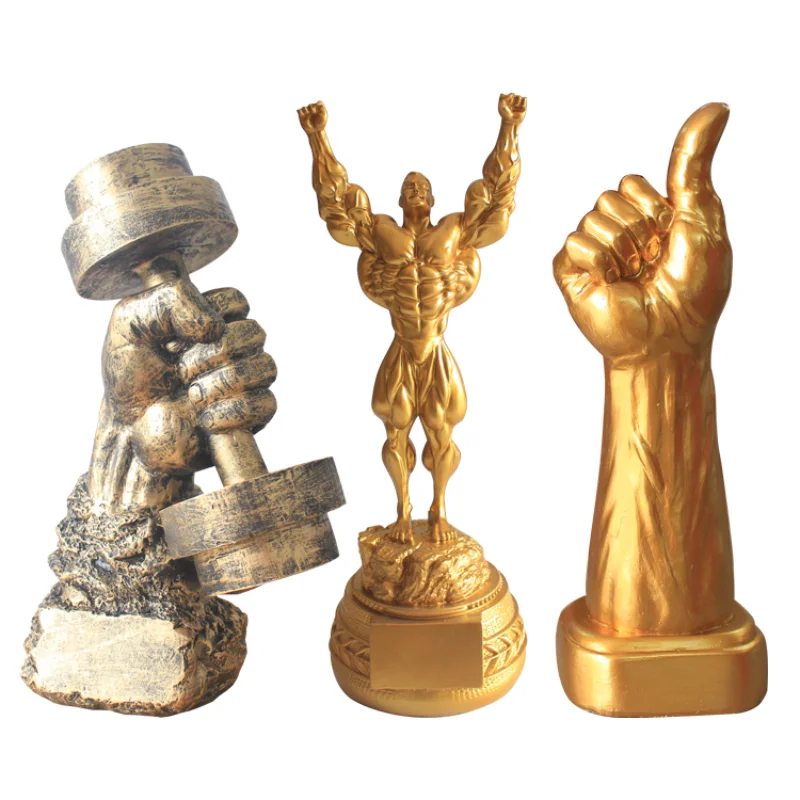 

Fitness muscle man sets up bodybuilding sports competition trophies, boxing figures, statues, sculptures, gym decorations