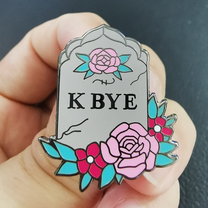 

K Bye gravestone lapel pin