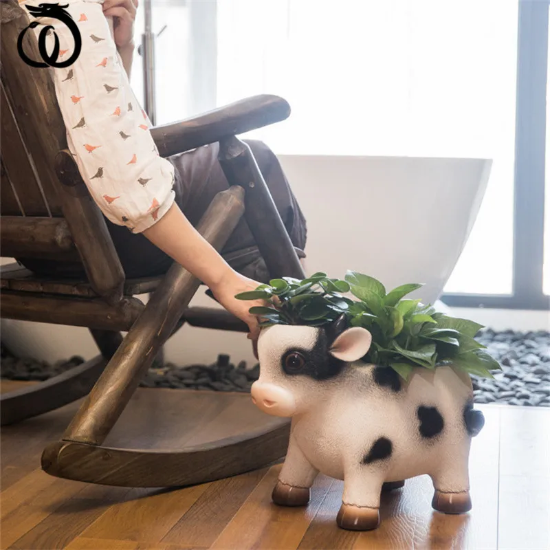 

WU CHEN LONG Creative Resin Cow FlowerPot Art Sculpture Cute Ox Statue Snacks Jewelry Key Storage Box Home Decoration R5885