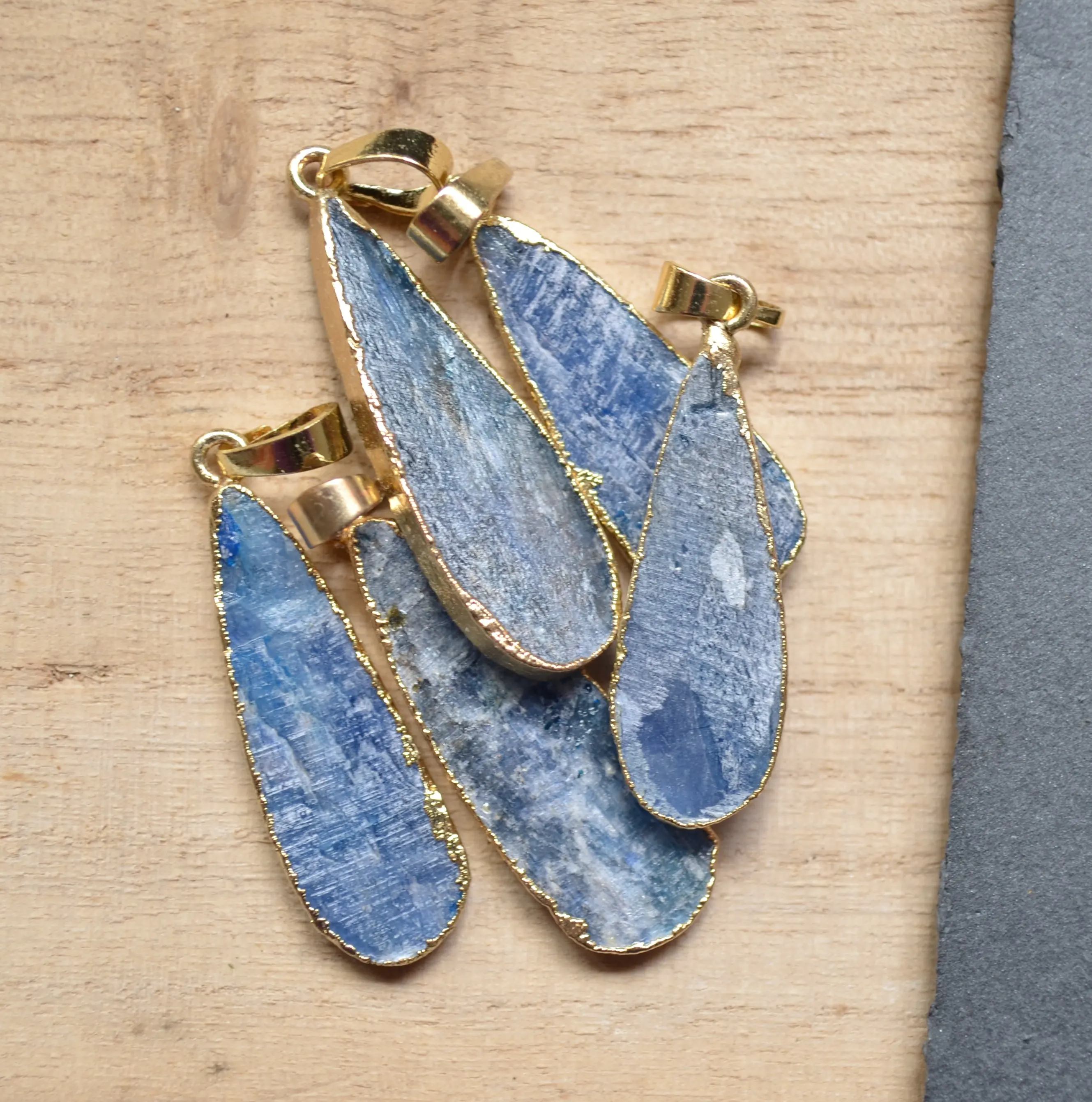 

Raw Blue kyanite water drop shape pendant with gold electroplated edges