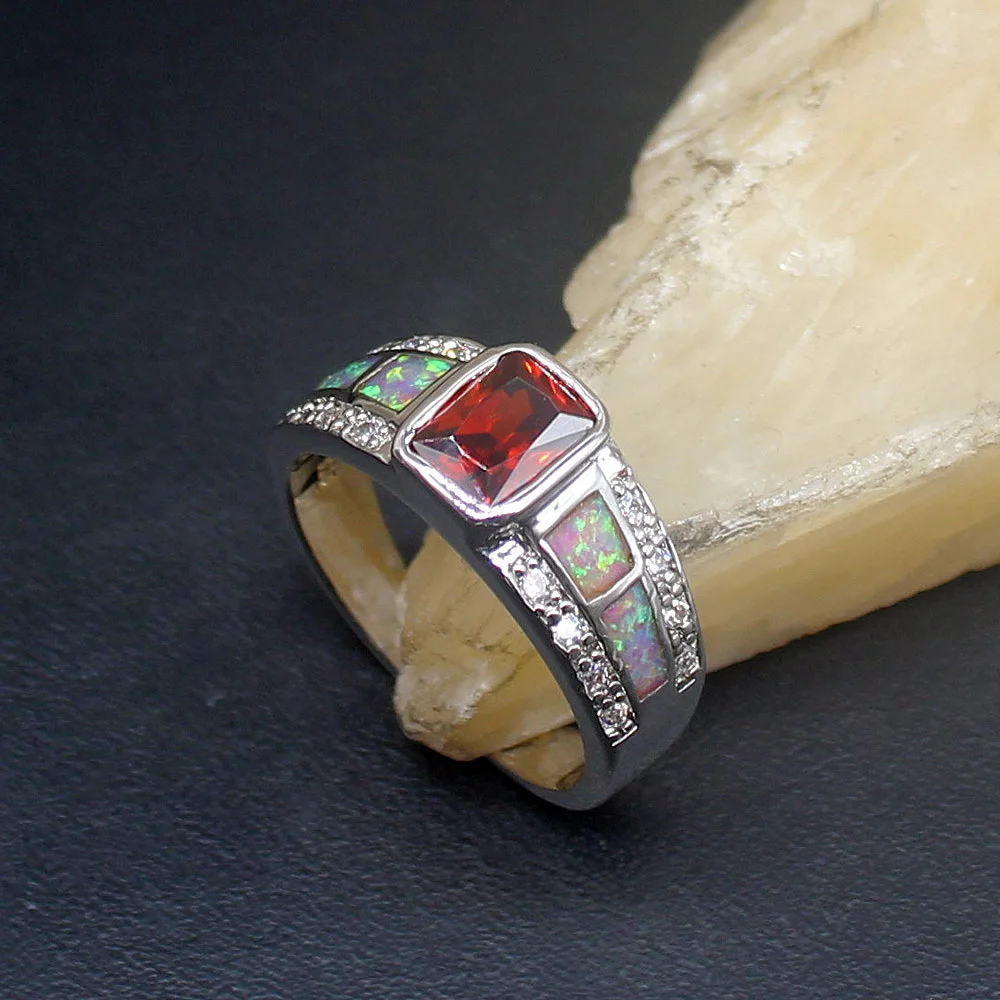 

Женское кольцо из серебра 925 пробы с мистическим опалом и красным гранатом
