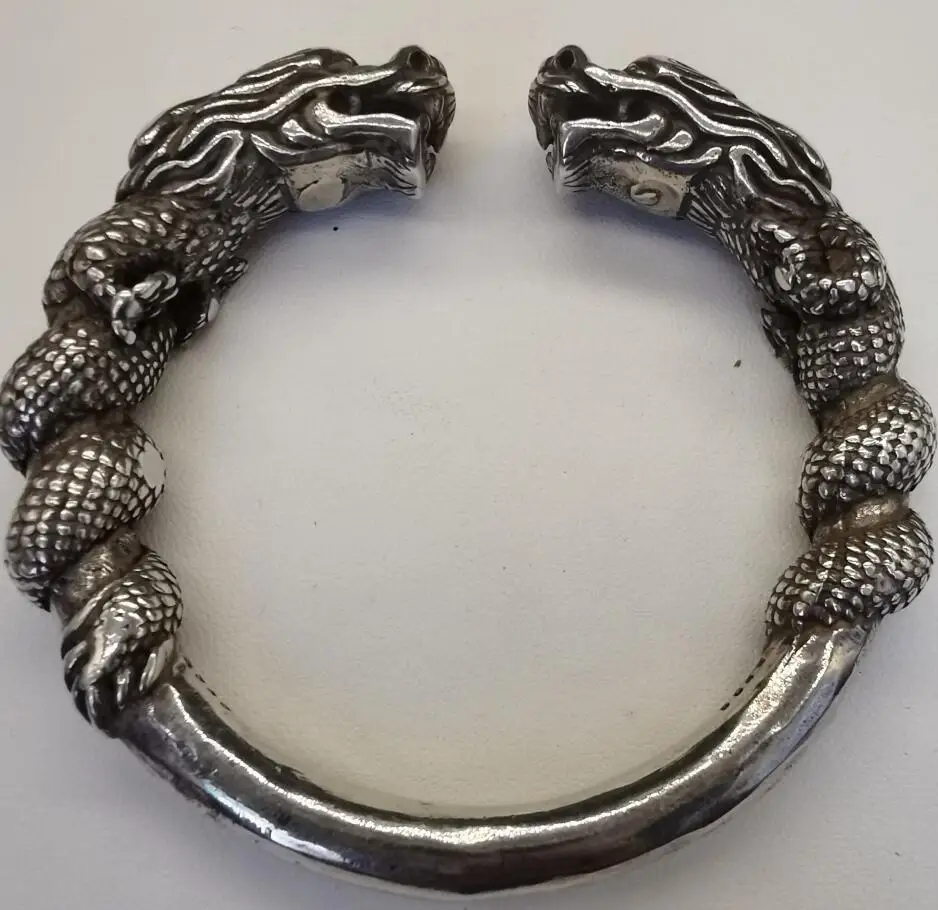 

Архаизированный браслет из белой меди с изображением двойного дракона