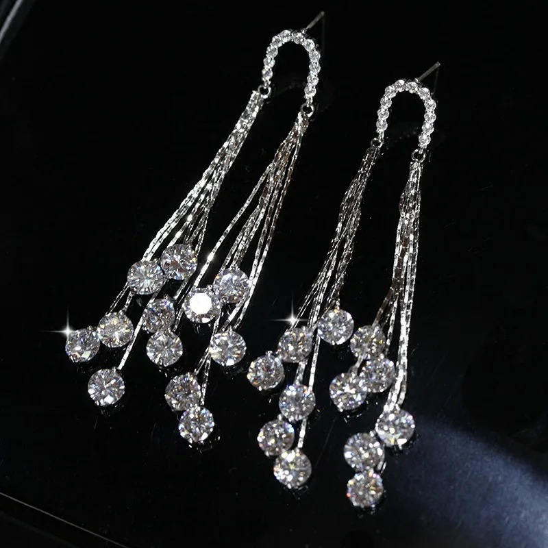 Женские серьги гвоздики серебряного цвета длинные с кисточками и блестящим