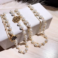 luxury hollow camellia pearl pendant flower sweater chain necklace for women