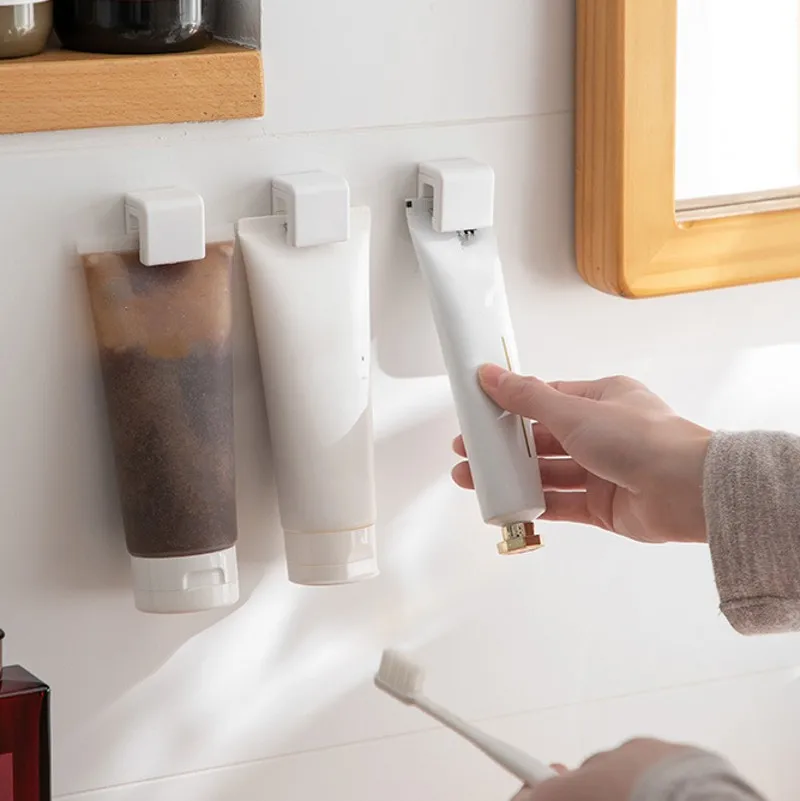 

2pcs Non-marking Toothpaste Holder Bathroom Hanging Clip Multi-purpose Toothpaste Cleanser Rack Plastic Toothpaste Storage Clip