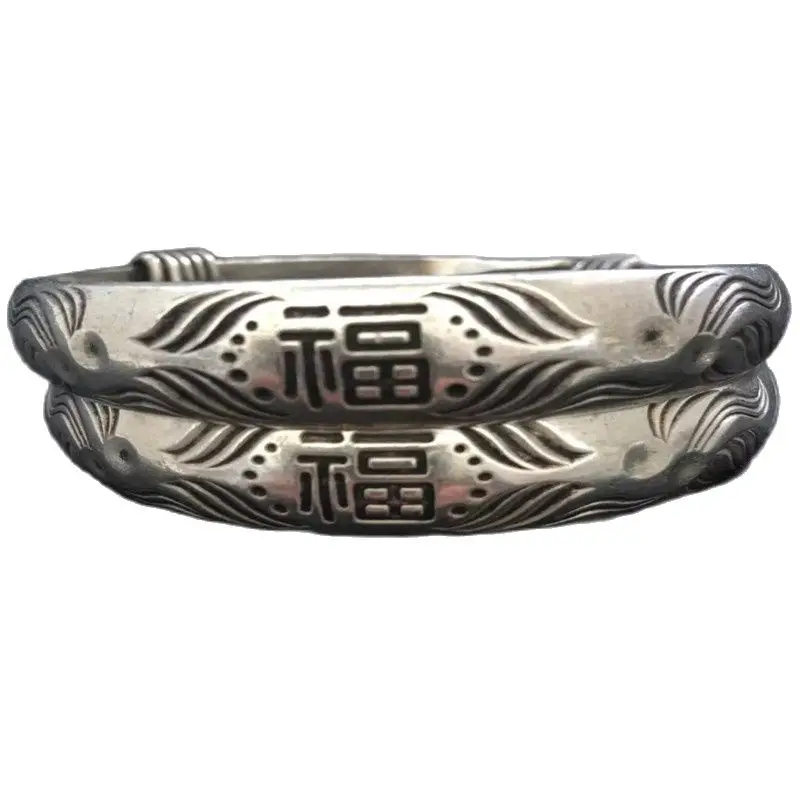 

of Chinese Miao silver bracelet with hand carved adjustment