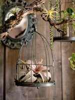 using vintage rustic metal bird cage for decor
