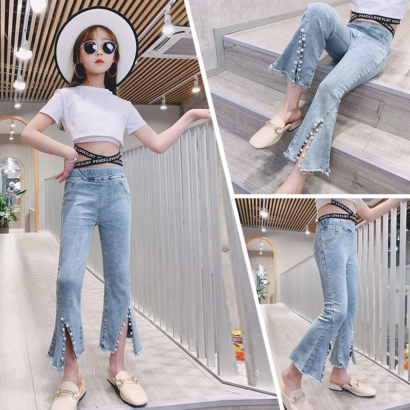 

Новые детские штаны для девочек, джинсы-трубы с широкими штанинами, штаны среднего и старшего возраста с принтом этикеток, украшениями на мо...