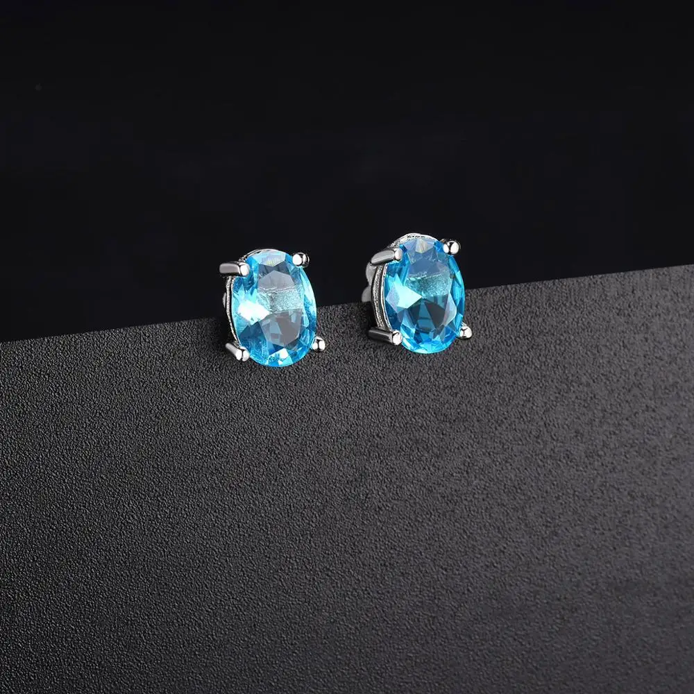 Серьги-гвоздики из серебра 925 пробы с голубым топазом 7*5 мм овальный камень