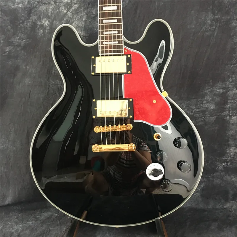 

Wholesale black jazz electric guitar, with golden pickup, red pearl shield, provide customized services.