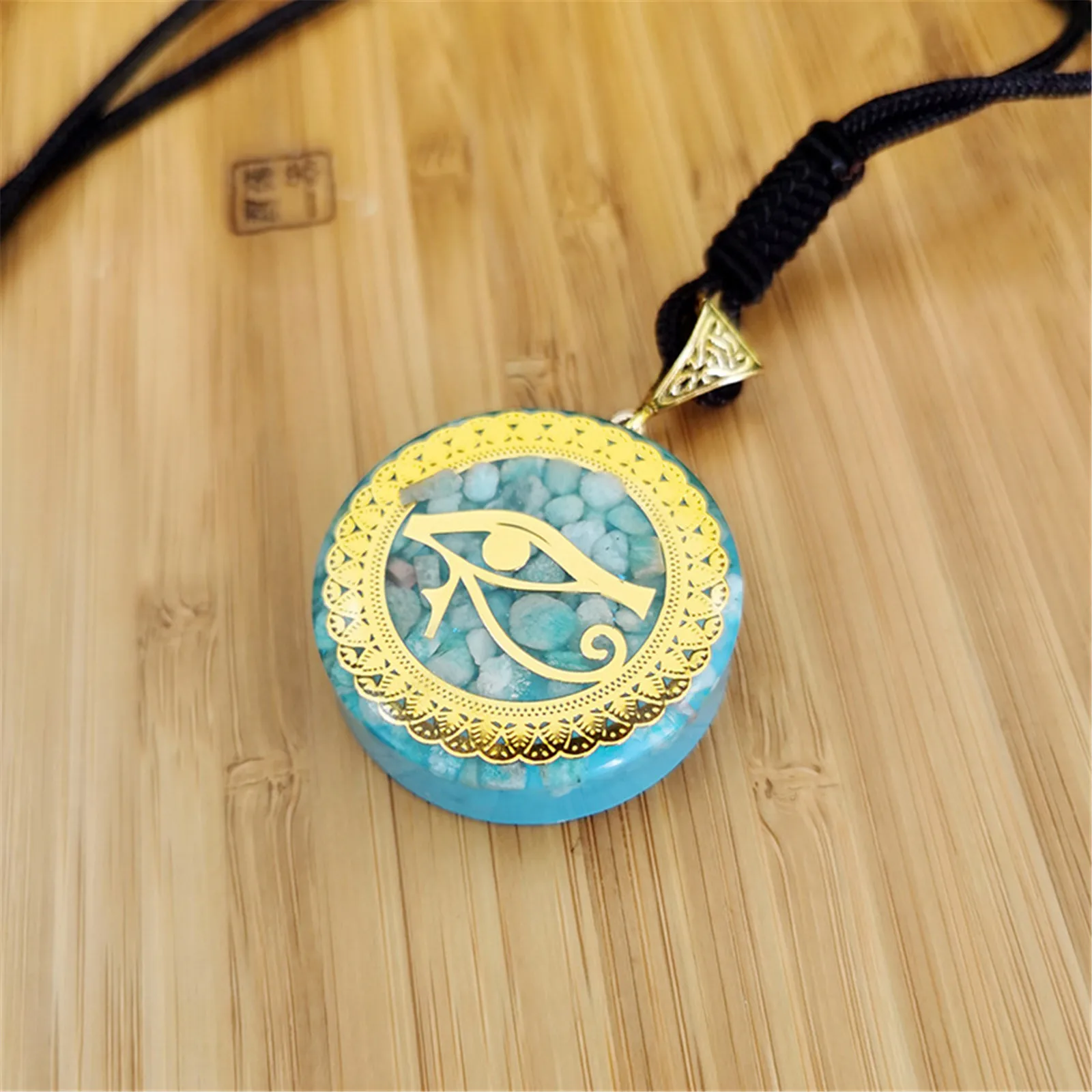 

Resin Eye of Horus Wedjat Orgonite Pendant Necklace for Men and Women with Small Natural Stones Inside Emblem of Lower Egypt