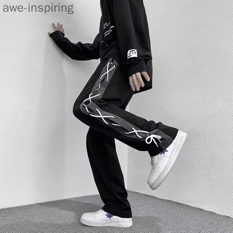 

Оригинальные повседневные уличные брюки, мужские брюки с широкими штанинами, прямые свободные дизайнерские брюки с плетеным шнурком, модны...