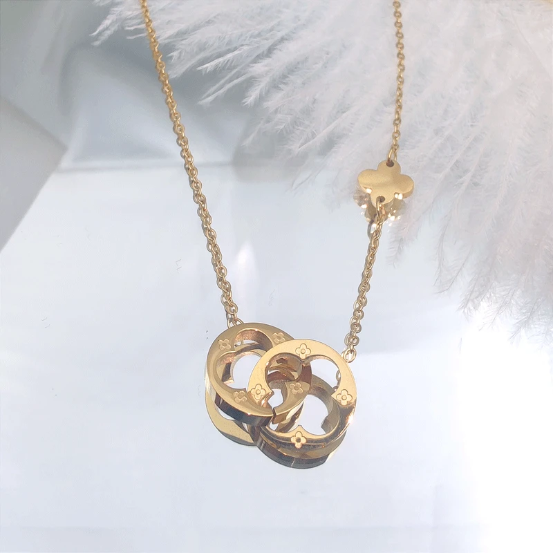 

Korean edition fashion personality exquisite double ring hollow 18K gold four-leaf clover titanium steel lady necklace