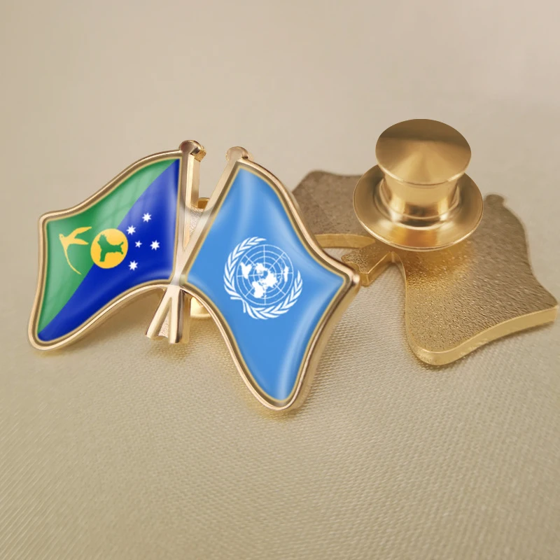 Брошь в виде двух соединенных элементов с изображением ООН и рождественского