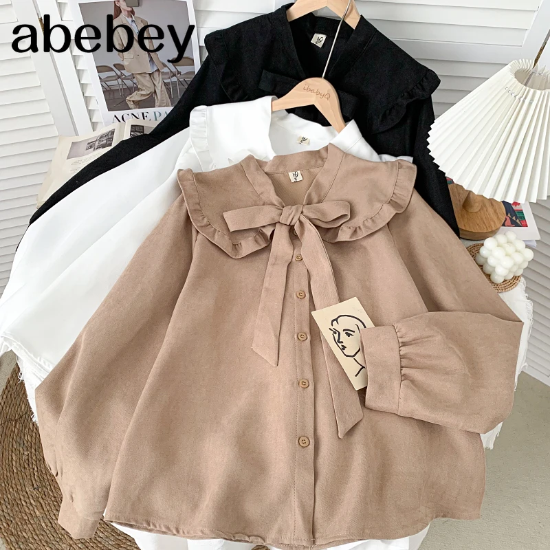 

Милая универсальная рубашка с кукольным воротником и длинным рукавом, бандажная однобортная свободная Однотонная рубашка с бантом, топ, но...