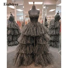 Длинное блестящее вечернее платье-трапеция из фатина на тонких бретелях