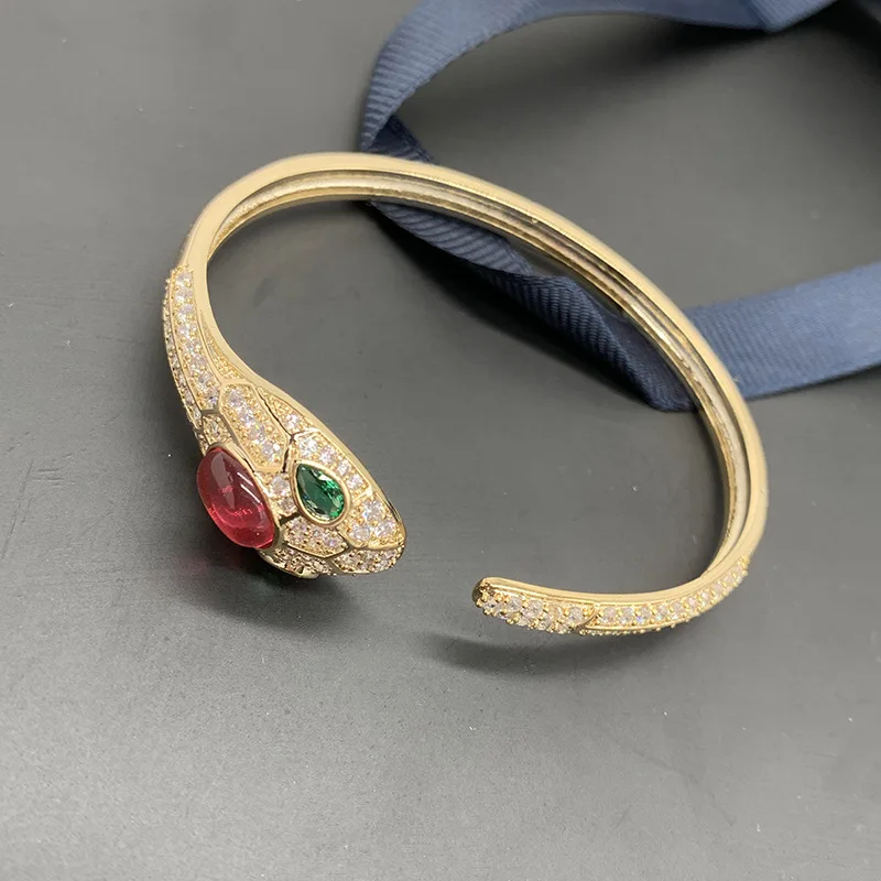 

European and American trend new simple ruby snake head bracelet men and women couple open bracelet green eyes full diamond snake