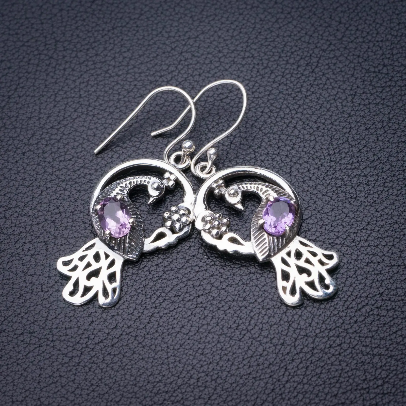 

Серьги из серебра 1,75 пробы с натуральным аметистом и павлином