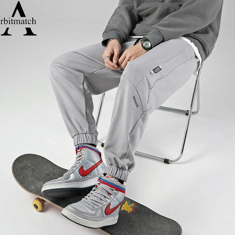 

Осенние мужские спортивные брюки, свободные спортивные штаны для бега, мужские светящиеся штаны для бега с буквенным принтом, мужские хлопк...