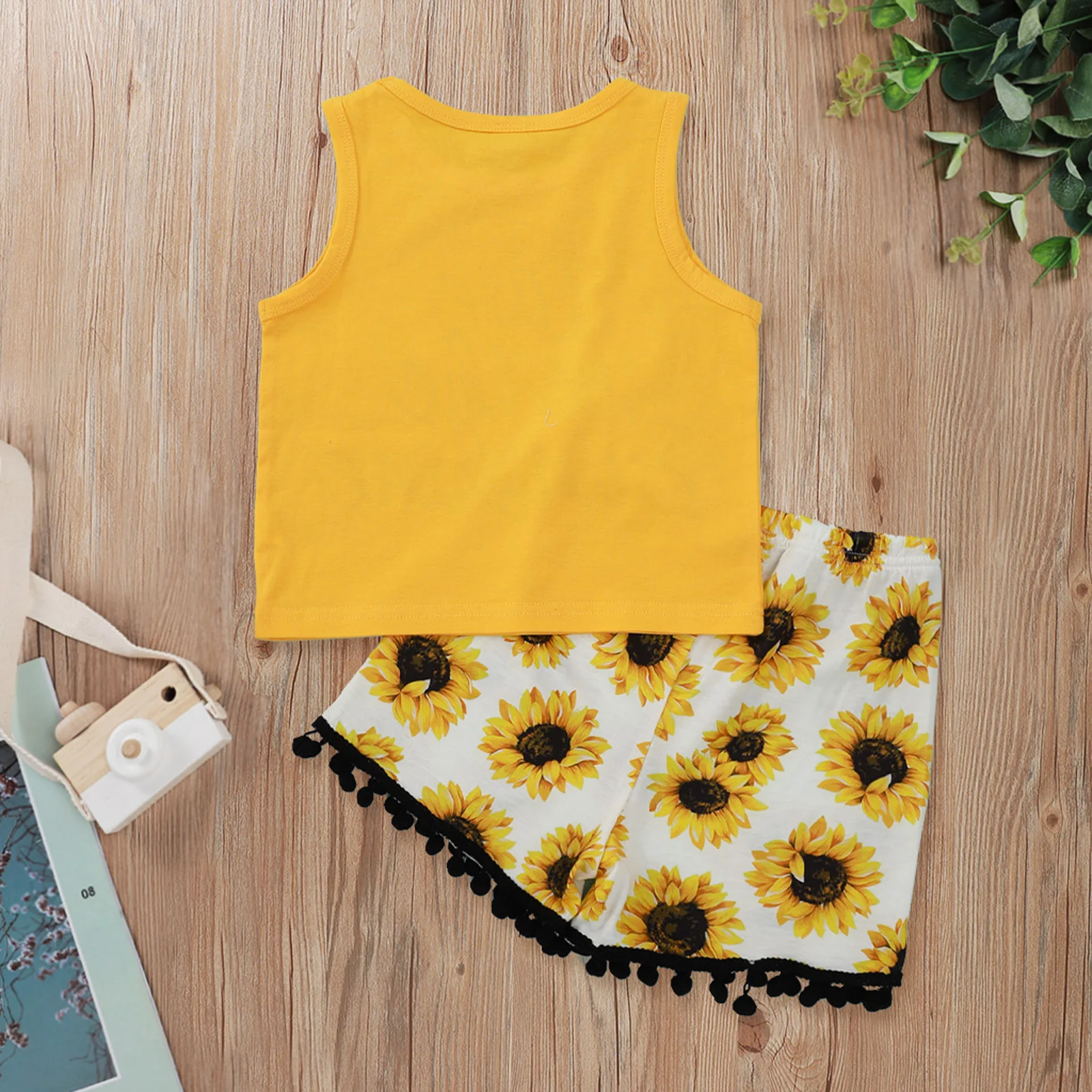 

Pudcoco 2021 Summer 1-5Y Baby Girl 2Pcs Set LIVE IN THE SUNSHINE Sleeveless Letter Print Vest Top+Sunflower Ball Tassels Shorts
