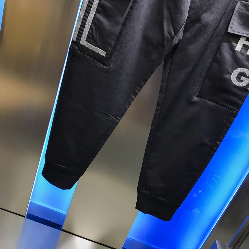 

2020 autumn new casual pants men's fashion brand personality handsome stripe pocket Lace Up Black Slim legged pants for men