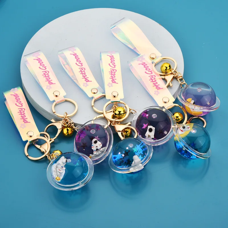 

2021 new creative cute astronaut planet doll keychain into oil floating astronaut liquid quicksand pendant bag ornament
